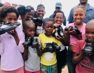 The Yiza kids holding their new school gear