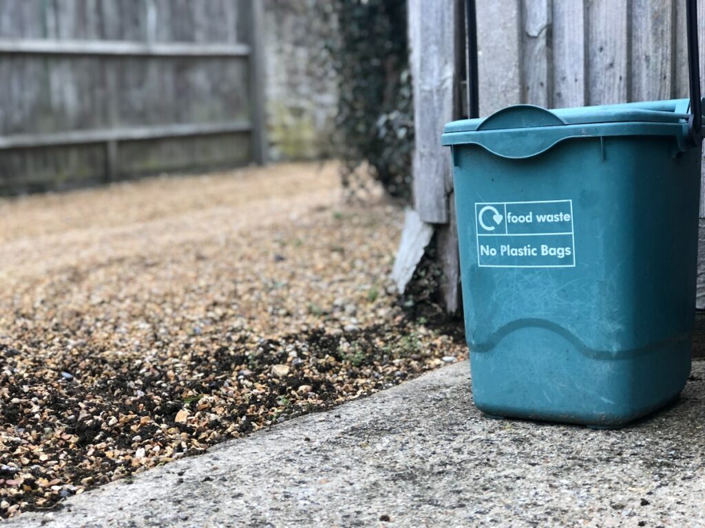 A compost bin standing outside