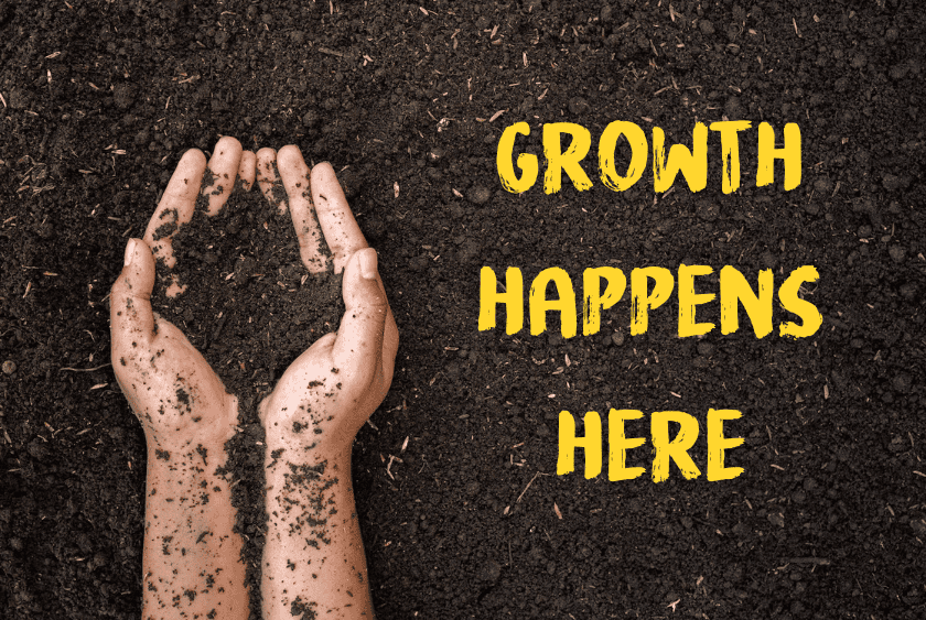 hands holding compost and the words growth happens here